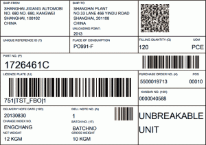 A Wareneingang shipping label with barcodes, reference numbers, and product details, including part number 1726461C, batch info, and the words UNBREAKABLE UNIT.