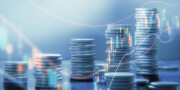 Stacks of silver coins arranged in rows with financial graphs and data overlays, representing investment and economic growth concepts.